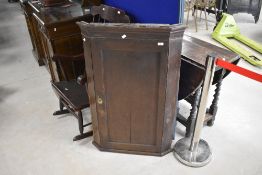 A 19th Century oak corner cupboard, having shaped shelves to interior, height approx. 108cm