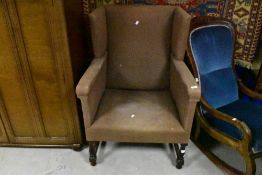 A large 19th century wing-back armchair, of angular design and of generous proportions, seat