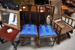 A pair of early 20th Century mahogany bedroom chairs having shaped legs and later blue upholstered
