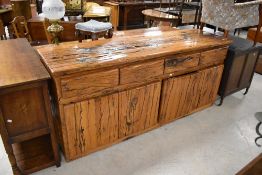 A substantial and impressive rustic wooden sideboard, thought to be Australian Jarrah, having an
