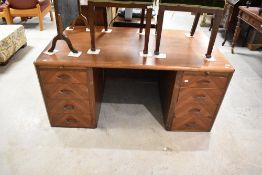 A vintage sapele office desk having four drawer section to each side with stationery and leather