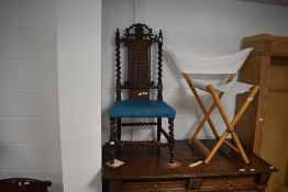 A Victorian oak hall chair, having a carved and pierced crest rail over a central caned panel and