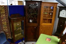 A George III string-inlaid mahogany double corner cupboard, the upper stage with overlapping