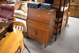 A vintage teak bureau, having fitted interior, over frieze drawer and double cupboard, width approx.