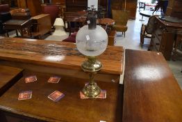 A traditional oil lamp having smoke glass chimney spherical part etched shade