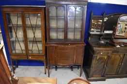 An Edwardian mahogany and line inlay display cabinet having glazed section over lower bowed