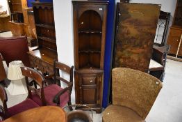 A good quality modern oak corner shelf of shallow proportions having cupboard under, most probably