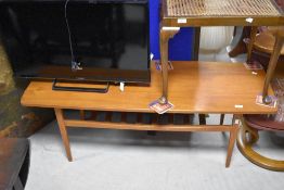 A vintage teak coffee table having slatted undertier, approx. 127 x 47cm