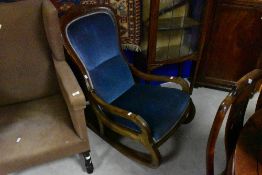 A Victorian mahogany part upholstered low rocking chair with incised detail and padded back and
