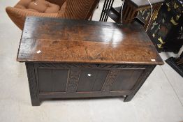 An 18th century oak three-panel coffer, the rectangular top with moulded edge detail opening on ring