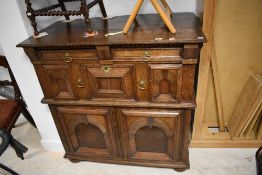 An interesting period oak side cabinet having two short drawers over one long , with cushioned