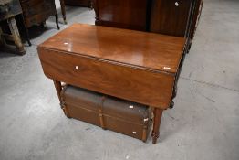 A Victorian mahogany dining table having frieze drawer and drop flaps having frieze drawer and