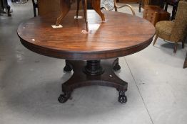 A 19th Century William IV style dark mahogany circular dining table having tilt top mechanism,