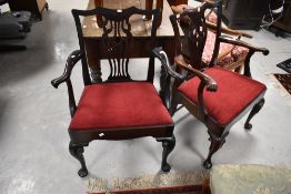 A pair of early 20th Century Chippendale style carver chairs having scroll arms, red dralon drop