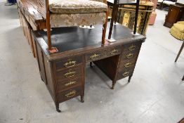 A Victorian mahogany desk having later coffin style handles and inset top, width approx. 122cm