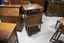 A late 19th or early 20th Century oak revolving bookcase having reading slope to side, and castors