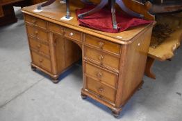 A late Victorian golden oak dressing table having plinth back and turned handles to the drawers,