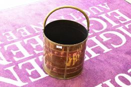 A traditional brass and copper banded coal bucket having swing handle, height to rim approx. 29cm