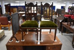 A pair of Victorian mahogany dining chairs having slat backs and overstuffed seats