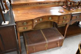 A 19th Century mahogany kneehole desk/dressing table having Regency style brass handles to the one