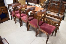 A group of four Victorian mahogany dining chairs, each with concave tablet top rail and carved mid