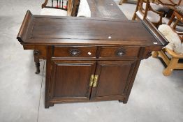 A Chinese pagoda style hardwood side cabinet , comprising two drawers over double cupboard,
