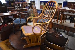 A vintage spindle back rocking chair having back and forth mechanism