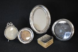 A George V silver mounted wooden photograph frame, of oval form, marks for Birmingham 1918, rubbed