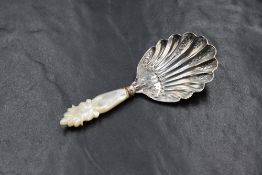 A Victorian silver and mother-of-pearl caddy spoon, having a scalloped bowl with decorative