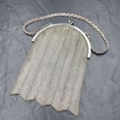 An Edwardian silver chain purse, having a silver crescent top with a ball clasp, on a braided