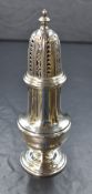 An Elizabeth II silver sugar caster, of traditional form having a decorative pierced top over a