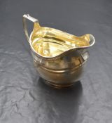 An Edwardian silver sauce boat, of traditional form having a moulded rim, the generous spout opposed