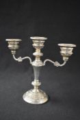 An Elizabeth II silver candelabra, the three branched having bead decoration to the circular scones,