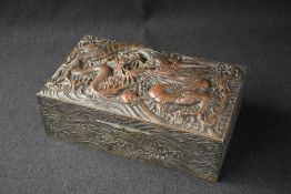 A 20th century Japanese silver plated box, of hinged rectangular form having an ornate dragon and