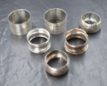 A pair of George V silver napkin rings, having vacant circular cartouches with line engraving, marks