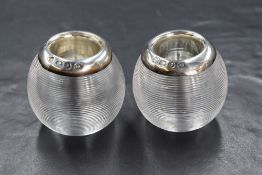 A pair of Victorian silver lined glass salts, of circular form having textured lines with a silver