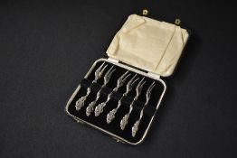 A cased set of six Elizabeth II Irish silver dessert forks, of ornate floral form with pierced