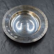 An Elizabeth II silver dish, of traditional form having a engraved line decoration to the rim with