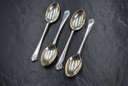 A set of four George V silver teaspoons, having golf motifs to the terminals, marks for Sheffield