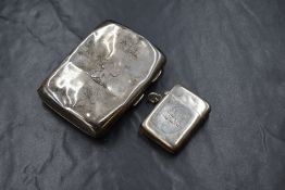 A Victorian silver vesta case, of hinged rectangular form having a heraldic crest to the centre,