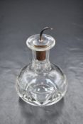 An Elizabeth II silver mounted glass bitters bottle, the glass body of bulbous form with flared rim,