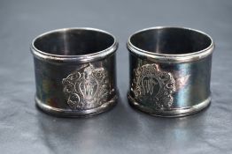 A boxed pair of Elizabeth II silver napkin rings, having an ornate shield with 'W' initial, marks