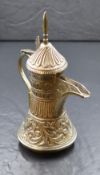 A 20th century Omani silver dallah coffee pot, of traditional form having a pointed finial over