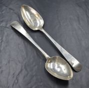 A matched pair of George III Irish silver Old English pattern serving spoons, having a heraldic