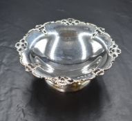 A George V silver pedestal bon bon dish, having an ornate pierced rim, raised on a circular step