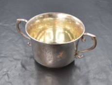 A George V silver sugar bowl, of traditional form having a slightly flared rim with scroll handles