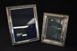 A group of four silver mounted photograph frames, three of vertical rectangular form having