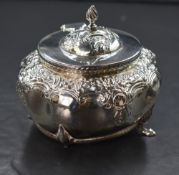 A Victorian silver sugar bowl, of oval form having embossed floral scroll and diaper decoration,