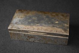 A George V silver cigarette box, of hinged rectangular form having a central vacant circular