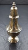 A George VI silver sugar caster, the finial over the pierced top having a baluster body, raised on a